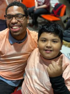 Two boys wearing orange shirts