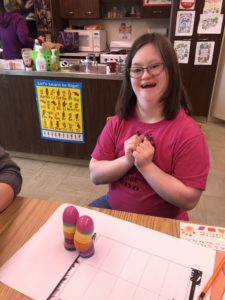 Girl in pink shirt smiling